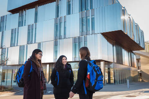 Three medical students having a conversation in front of the Mississauga Academy of Medicine