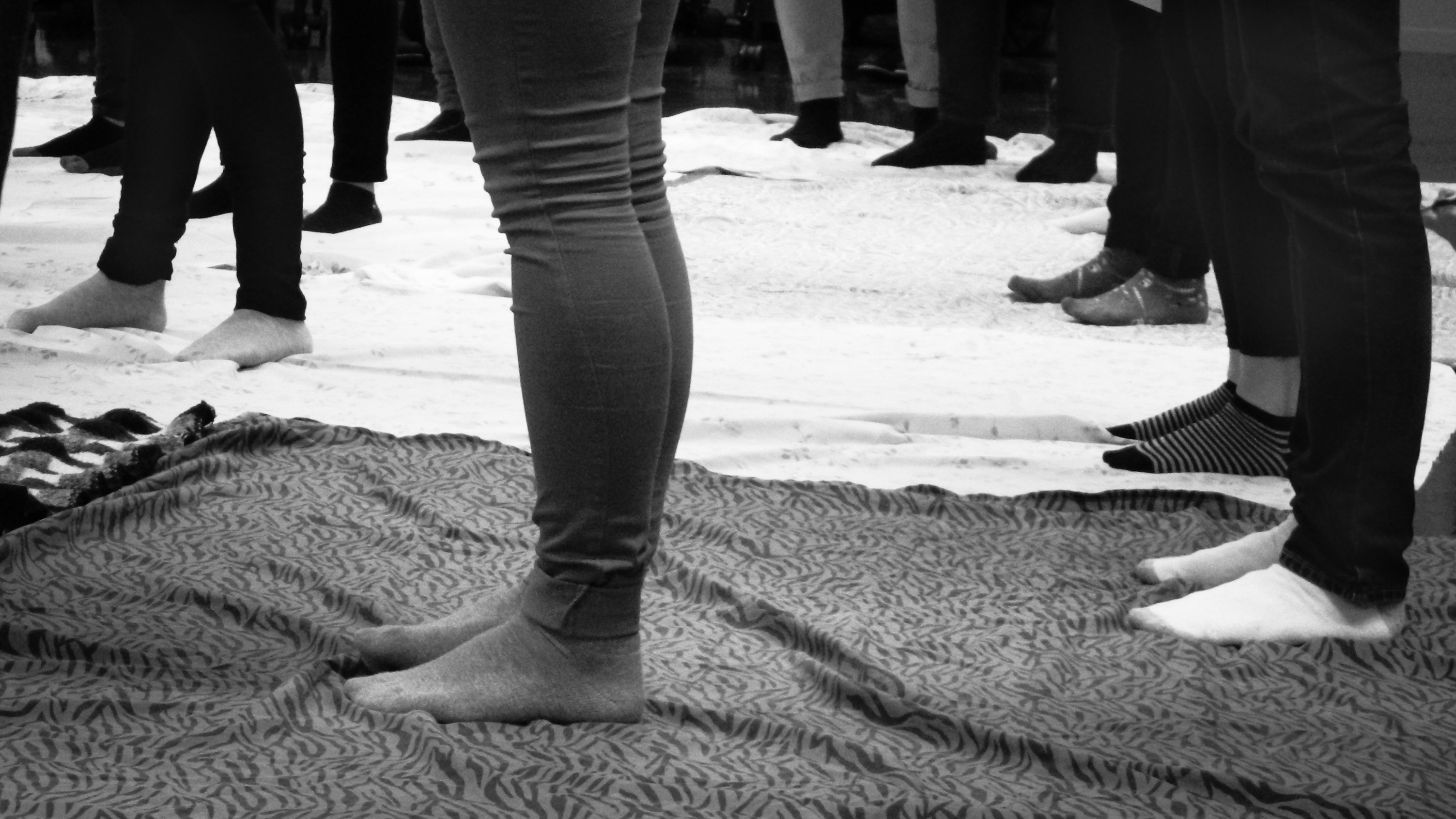 Unidentifiable students stand on blankets as part of the blanket exercise.