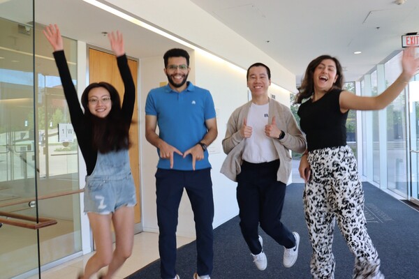 A group of people jumping in a hallway