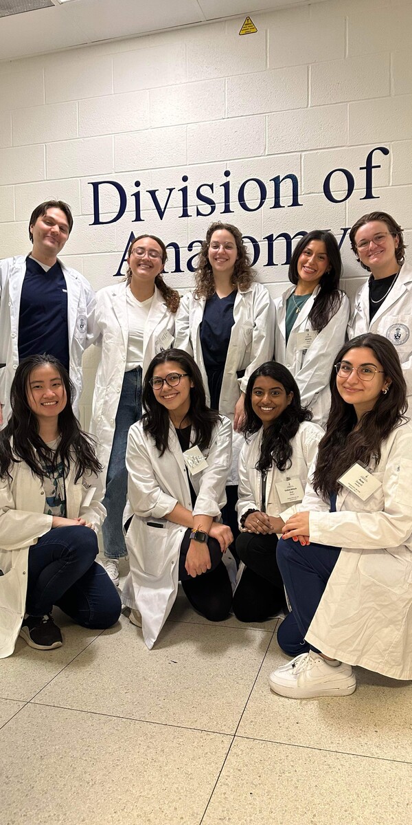 A group of people in white lab coats posing for a photo