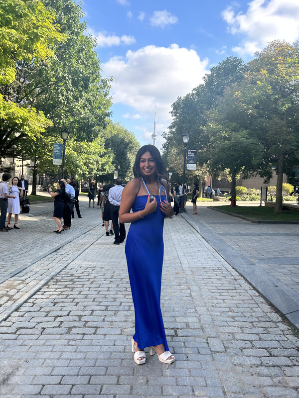 A person smiling in a blue dress