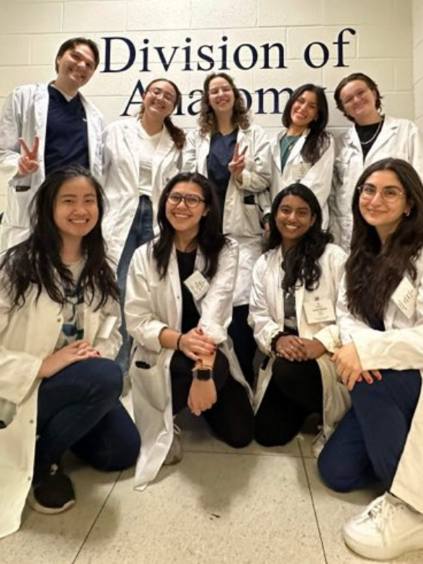 Smiling group in white lab coat