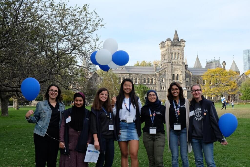 Group of students on campus holding balloons
